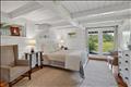 Lower-level bedroom with en suite bath and sliders out to the yard.