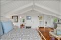 Second floor primary with en suite bath and private deck.