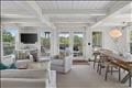 Living room opens to a screened porch and a side deck.