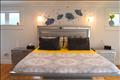 primary bedroom with private bath, balcony and walk-in-closet