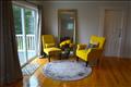 Sitting area leads to private balcony in primary bedroom