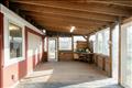 Three Season Porch with a Door to the Outdoor Shower and Sliding Doors with views to the Meadow.