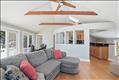 Livingroom to kitchen and deck. Primary private bedroom through the door on the left