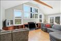 Amazing wall of windows letting in abundant light custom built-in cabinets and high vaulted ceiling