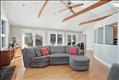 Bright open concept living space to outdoor deck three sliders