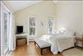 Primary bedroom with high vaulted ceiling.