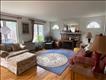 Large front windows in sunny living room w/ Palladian side windows and hardwood floors