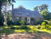 attractive home with skylights, brick wood burning fireplace, beautiful yard w/flowers and mature landscaping