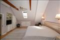 Alternate view of the master bedroom with skylight.