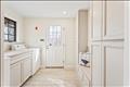 Side entrance mud room with Speed Queen washer & dryer, custom cabinetry renovated in 2025