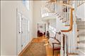 Elegant carved staircase leads to the second floor from the grand foyer.