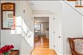 Light filled entry way leads to the kitchen, stairs to the second floor