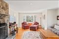 Living Room features oak floors and beautiful bay windows