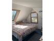 Partial view:  Guest House bedroom. There is an adjacent sitting room.