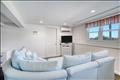 Finished lower level offering a spacious lounge area.