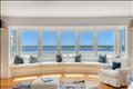 The living room with expansive window wall that offers panoramic views of Katama Bay