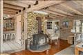 Beach stone chimney and wood stove for cozy gatherings with family and friends