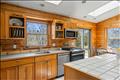 Guest house kitchen with casual dining area leading to large back deck, plus  center island and seating