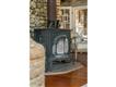 Wood stove accents the beach stone fireplace and provides warmth on chilly evenings