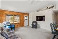 Open floor plan with vaulted ceilings, skylights and front door from the large porch and sliding doors to the enormous  back deck with bench seating, grill station and outdoor shower/dressing area