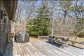 Guest house back deck with room to grill and gather. Walkway to large basement with pool table and cedar closet storage and custom outdoor shower