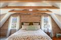 2nd flr - Primary Bedroom with walk-in closet wood floors and vaulted ceilings