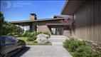 The formal front entrance offers water views as guests approach the home - as envisioned by the architectural rendering.