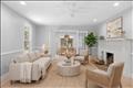 Large living room with Rumford fireplace with french doors that open to the dining room. Virtually staged.