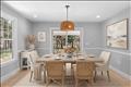 Dining room conveniently located between the living room and kitchen, with sliders out to the porch. Virtually staged.