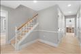 Front entrance foyer with living room to the left and hallway to kitchen, powder room and 1st floor bedroom on the right.