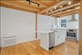Open concept gourmet kitchen with island eatery, Quartz counters, custom millwork and lots of natural light.