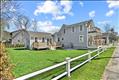 Luscious side yard and outdoor living area, privacy fencing and sidewalk to town.