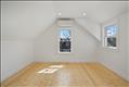 Main bedroom in primary unit with hardwood oak flooring and climate control.