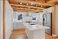 Open concept gourmet kitchen with island eatery, Quartz counters, custom millwork and lots of natural light.