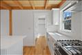 Gourmet kitchen flows to walk-in chef's pantry.