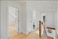 Second level landing and hallway to two bedrooms and full bathroom in primary unit.
