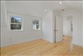 Main bedroom in primary unit with hardwood oak flooring and climate control.