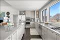 The renovated kitchen is modern and bright.