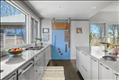 Decorative barn door conceals a generous pantry space.