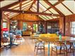 Great room with a fireplace, living room and dining room. Doors on both sides of the room leading to a private patio and firepit as well as a deck on the south side.