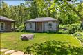 A detached, unfinished bonus structure offers a blank canvas with incredible potential that could be easily transformable into a private guest bunkhouse, a serene home office, or an artist’s studio