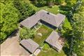 An aerial view showcases the home’s striking pavilion-style architecture, centered around a private, sunlit courtyard and surrounded by lush greenery