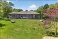 An expansive, sun-drenched deck on the back of the house that offers the perfect vantage point for outdoor entertaining, showcasing panoramic views of the beautiful rolling hills