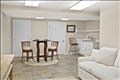 The finished lower level features a spacious, casual family room, an ideal secondary living space perfect for movie nights, relaxation, or quiet lounging
