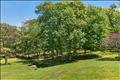 The property’s breathtaking acreage features scenic rolling hills accented by dramatic glacial boulders and lush, mature plantings that provide both vibrant seasonal color and exceptional privacy