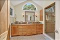 Spa-like primary bath with custom wood cabinetry and a double vanity