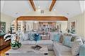 Living room that is light and bright with exposed beams