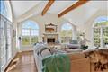 The heart of the home features an expansive, light-filled living room anchored by a beautiful fireplace