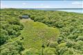 Aerial view showcasing the home nestled in lush privacy with sweeping waterviews of the Vineyard Sound