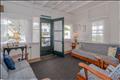 Inviting spacious living area featuring a high white painted beam ceiling.